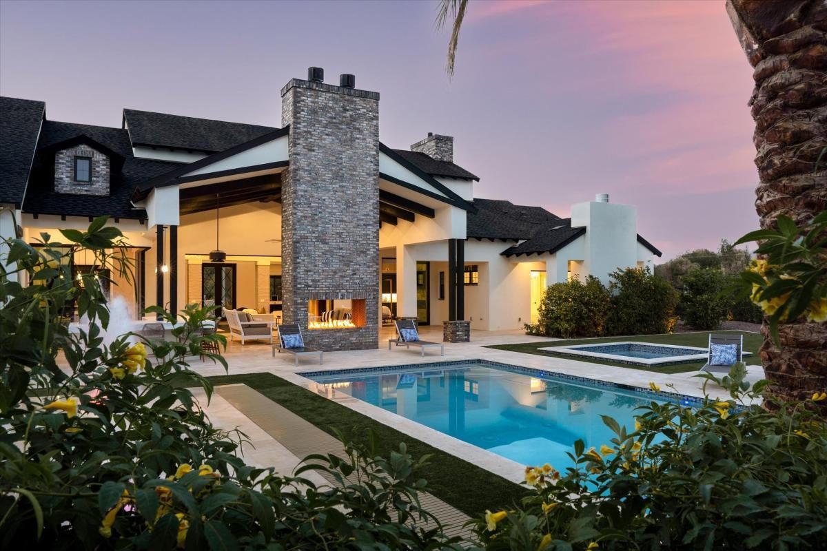 Pool and chimney at dusk, built by Bel Aire